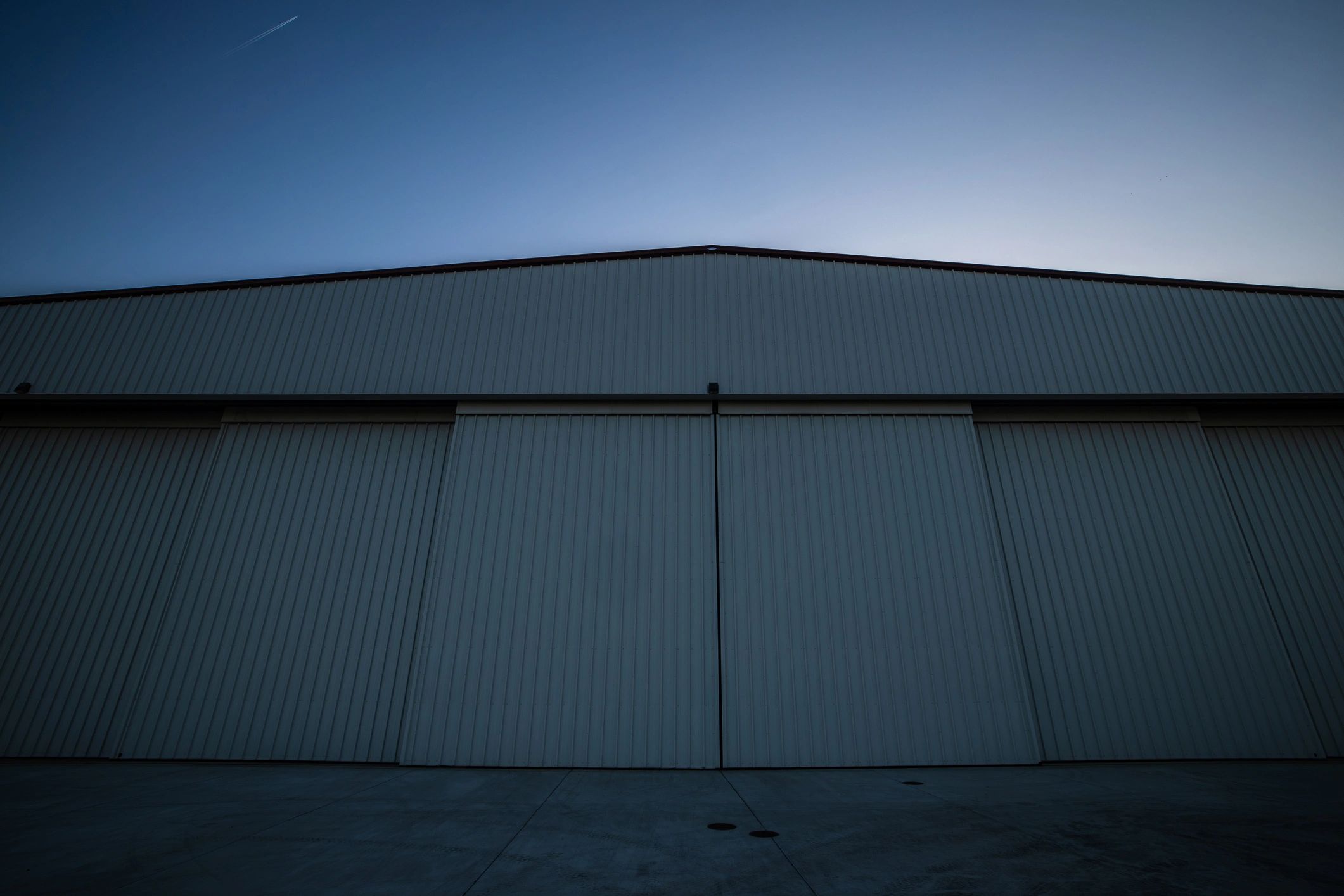 Large steel-framed commercial structure at sunset