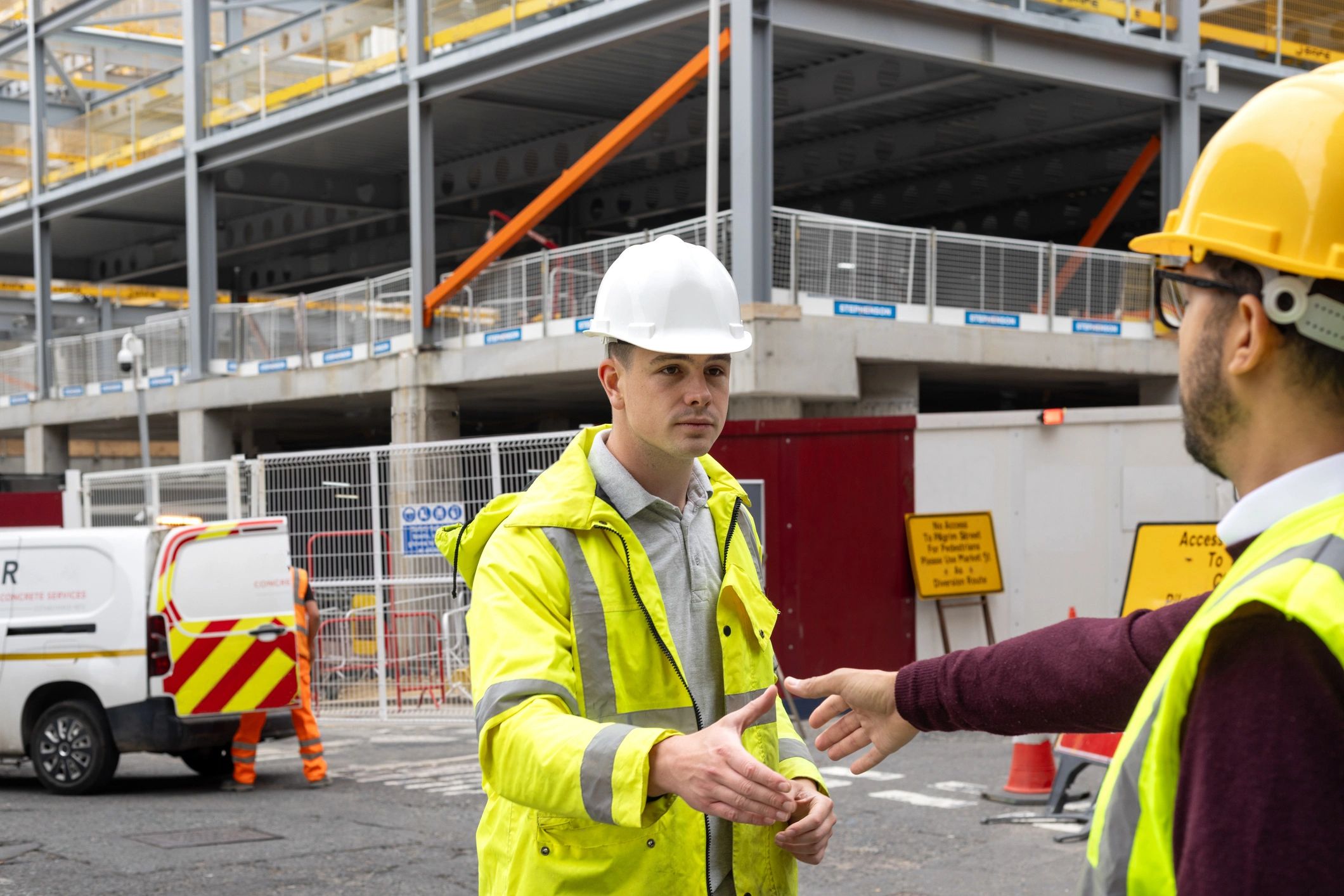 Two construction professionals shaking hands at a jobsite